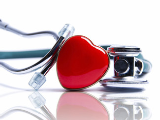 A picture of a stethoscope and a heart figurine.