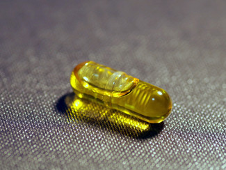 A supplement capsule filled with CBD oil.