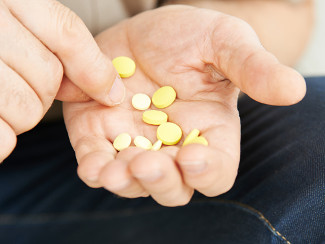 Senior citizen holding their medication.