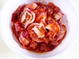 A bowl of Pumpkin Tortellini with Cranberry Marinara Sauce.