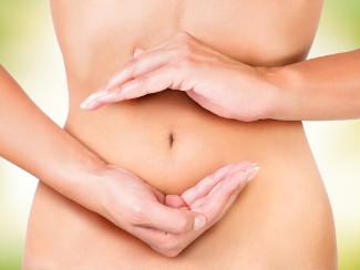 A woman's belly, with her hands creating a circle around it, representing the digestive cycle.