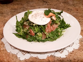 A plate of dandelion green and grapefruit salad.